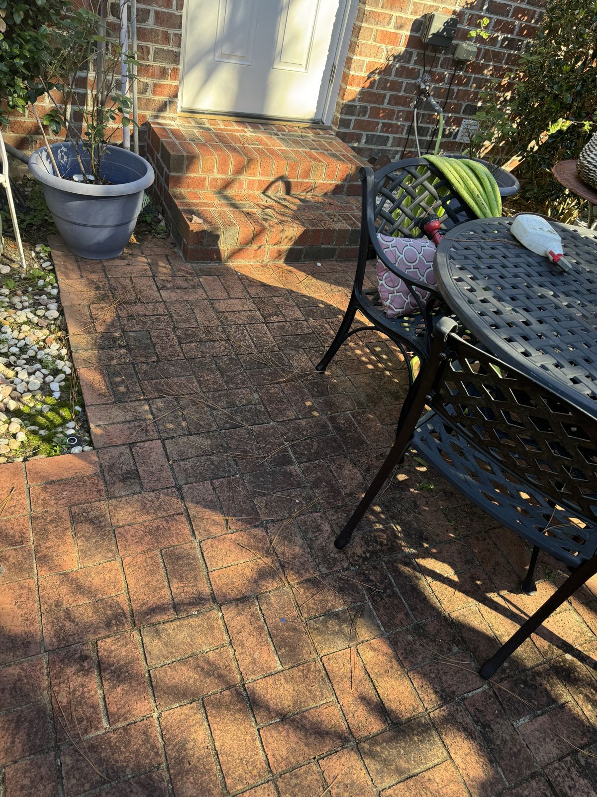 Brick patio before exterior cleaning by Omni Home