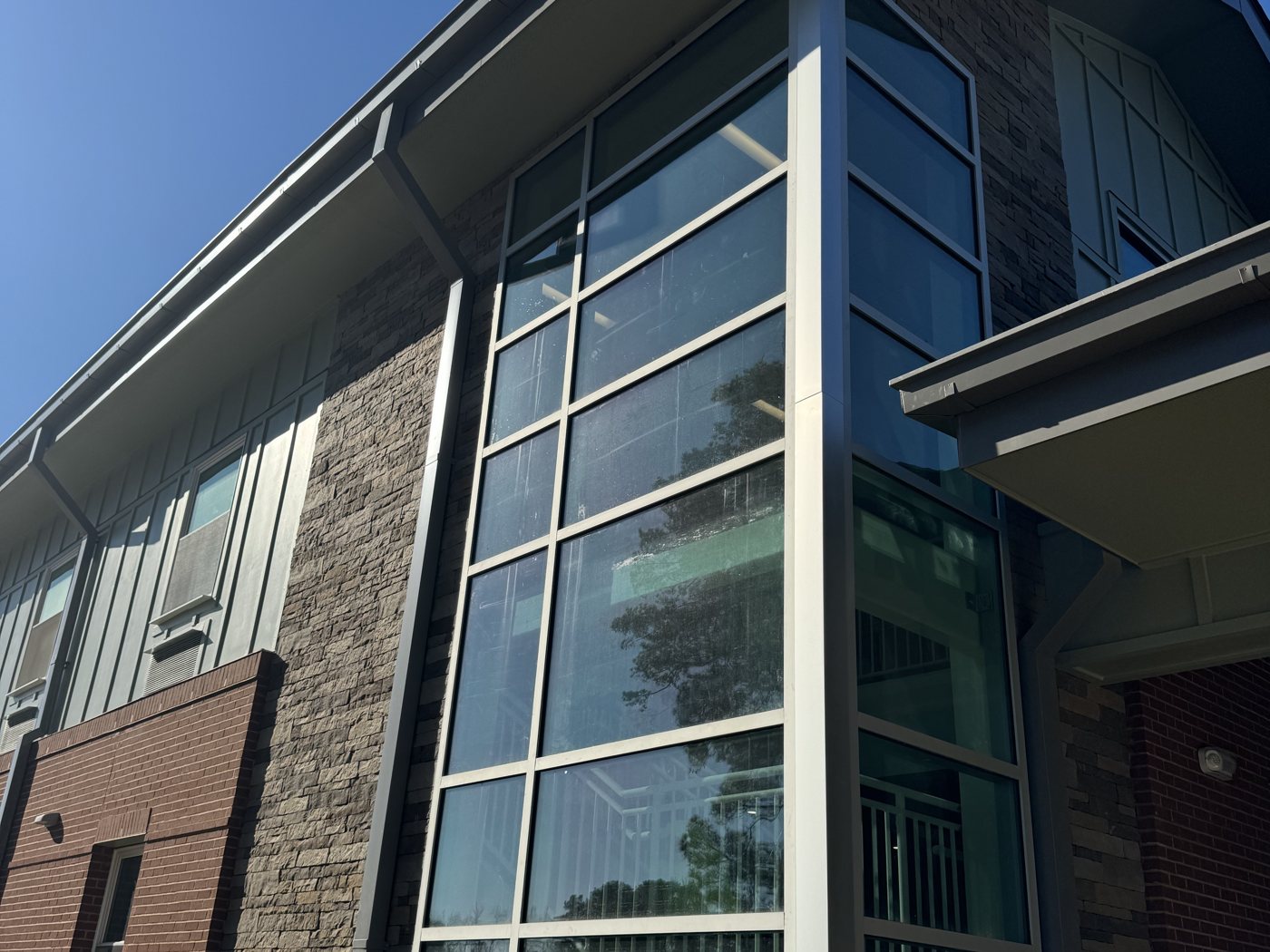 Commercial glass curtain wall cleaned by Omni Home