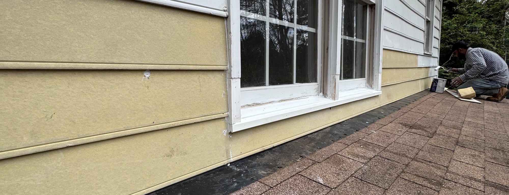 Omni Home crew member painting siding and trim