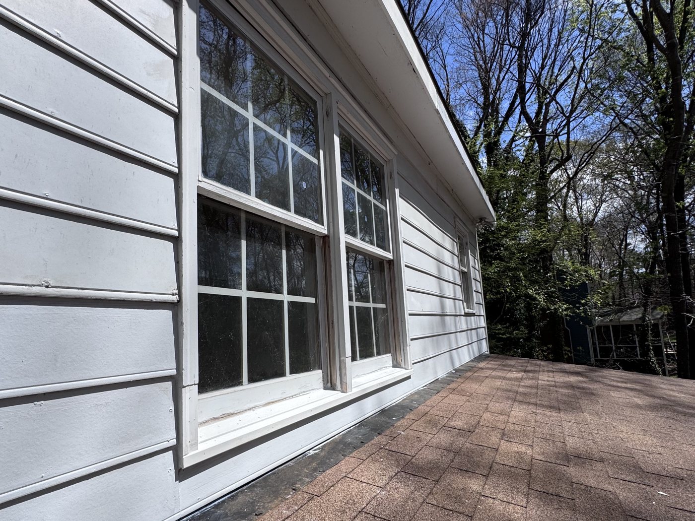 Exterior siding and window trim on a home serviced by Omni Home Property Care