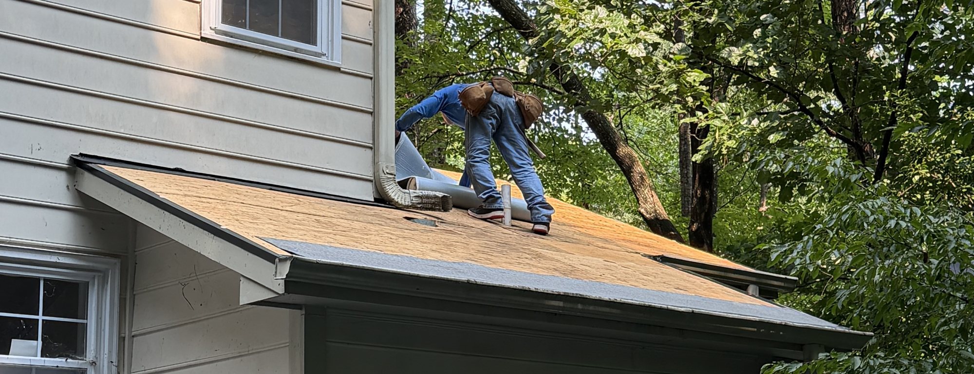 Omni Home crew member tearing off a damaged roof section