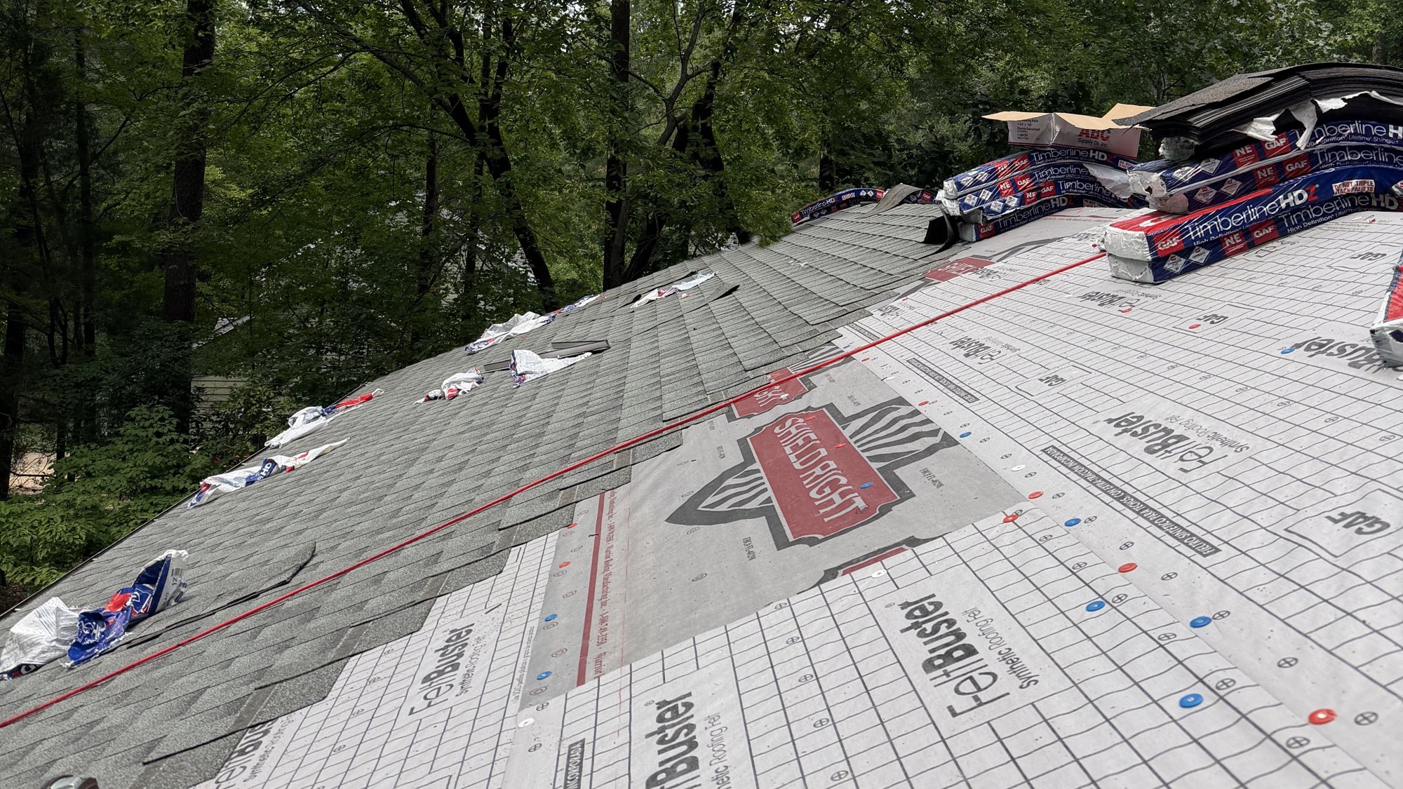 Roof replacement in progress by Omni Home, new architectural shingles going on